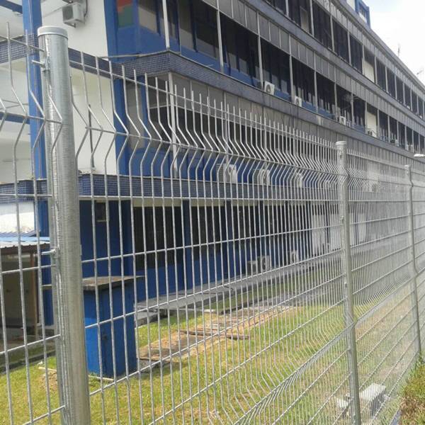 Curvy welded fence is used to create boundaries for office buildings.